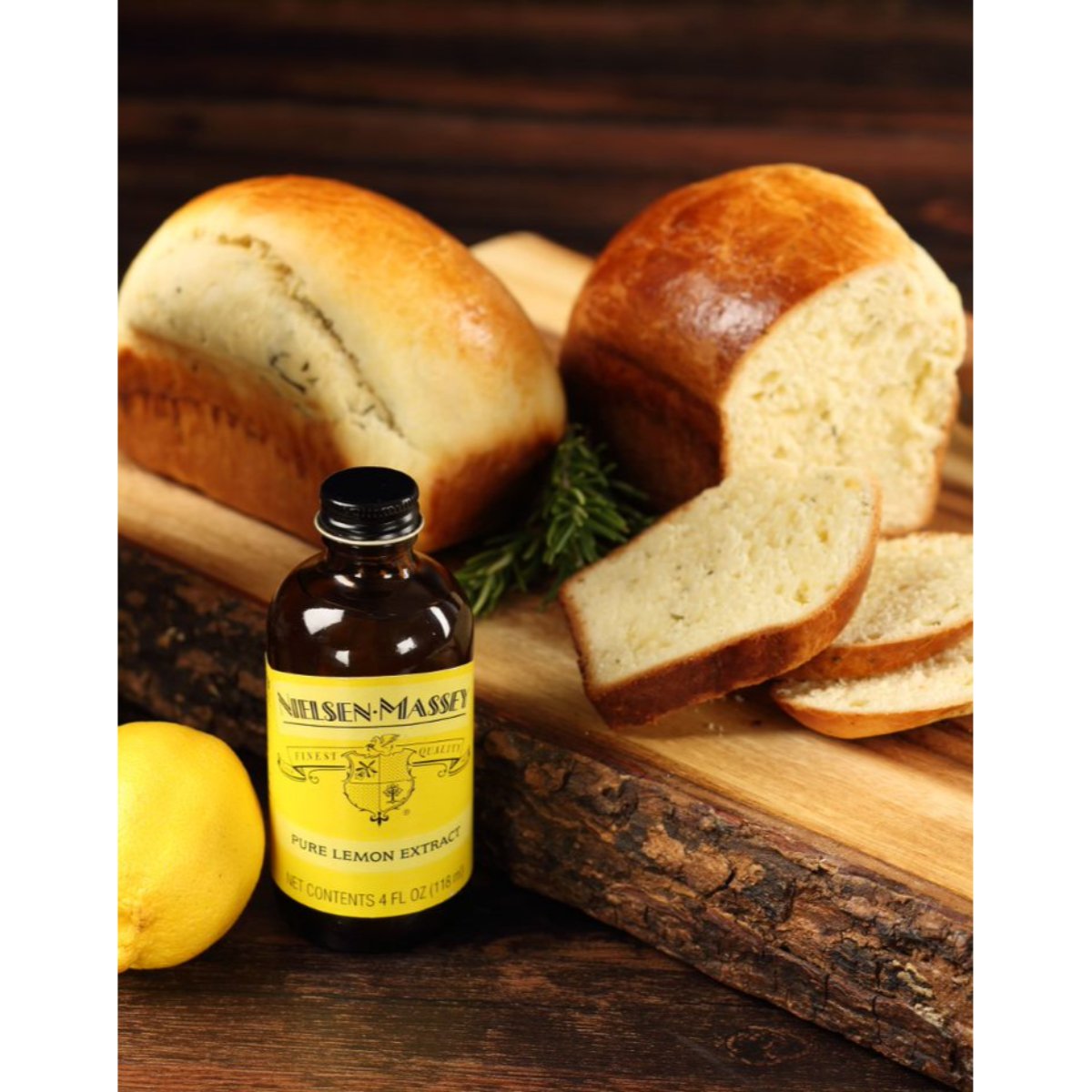 Nielsen-Massey pure lemon extract in 2 oz and 4 oz bottles, showing clear liquid and label on the product.
