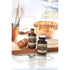 Nielsen-Massey Pure Vanilla Extract bottle in 2, 4, 8, or 32 oz sizes, clear glass with label, on a kitchen countertop.