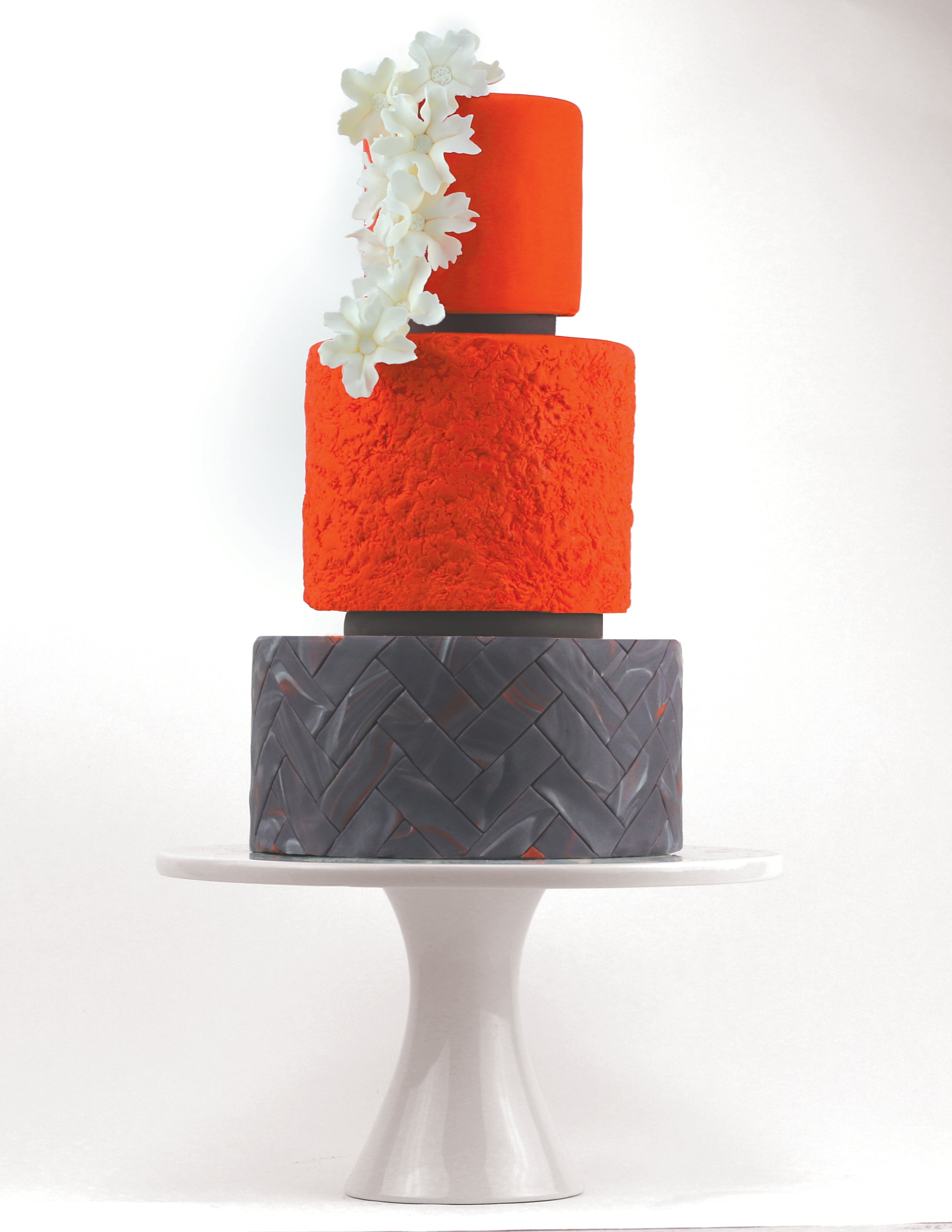Satin Ice fondant in various colors and sizes, soft and smooth icing for cake decorating, shown in the image.