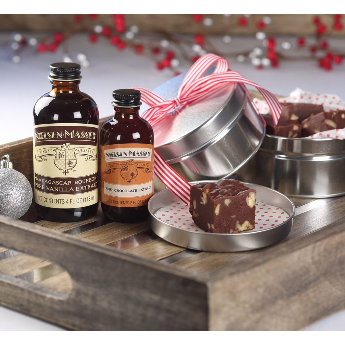 Nielsen-Massey Pure Chocolate Extract bottles in 2 oz and 4 oz sizes, showing clear glass containers with dark chocolate extract inside.